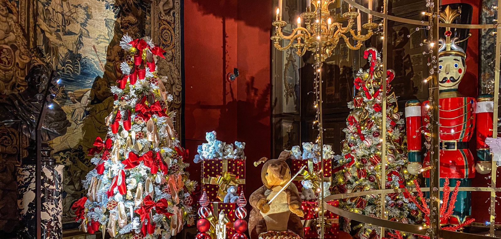 Vaux-le-Vicomte Christmas Toys Room Lavish Vaux-le-Vicomte room decorated for Christmas with trees, toys, gifts and a giant nutcracker under warm candlelight