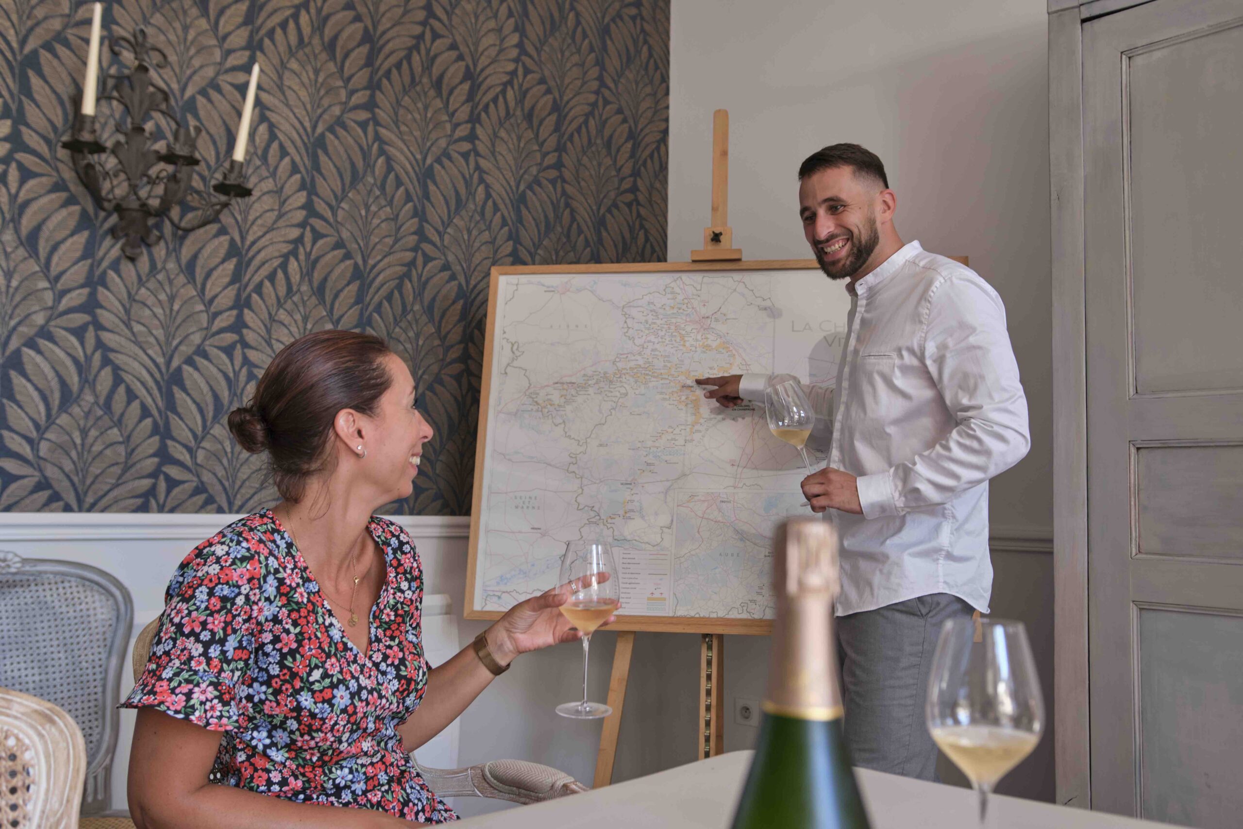 Private Wine Tasting & Food Pairing Paris | Expert-Led French Wine Region Education Experience Private Wine Tasting Paris - sommelier teaching French wine regions with map during Paris and Beyond Tours pairing experience