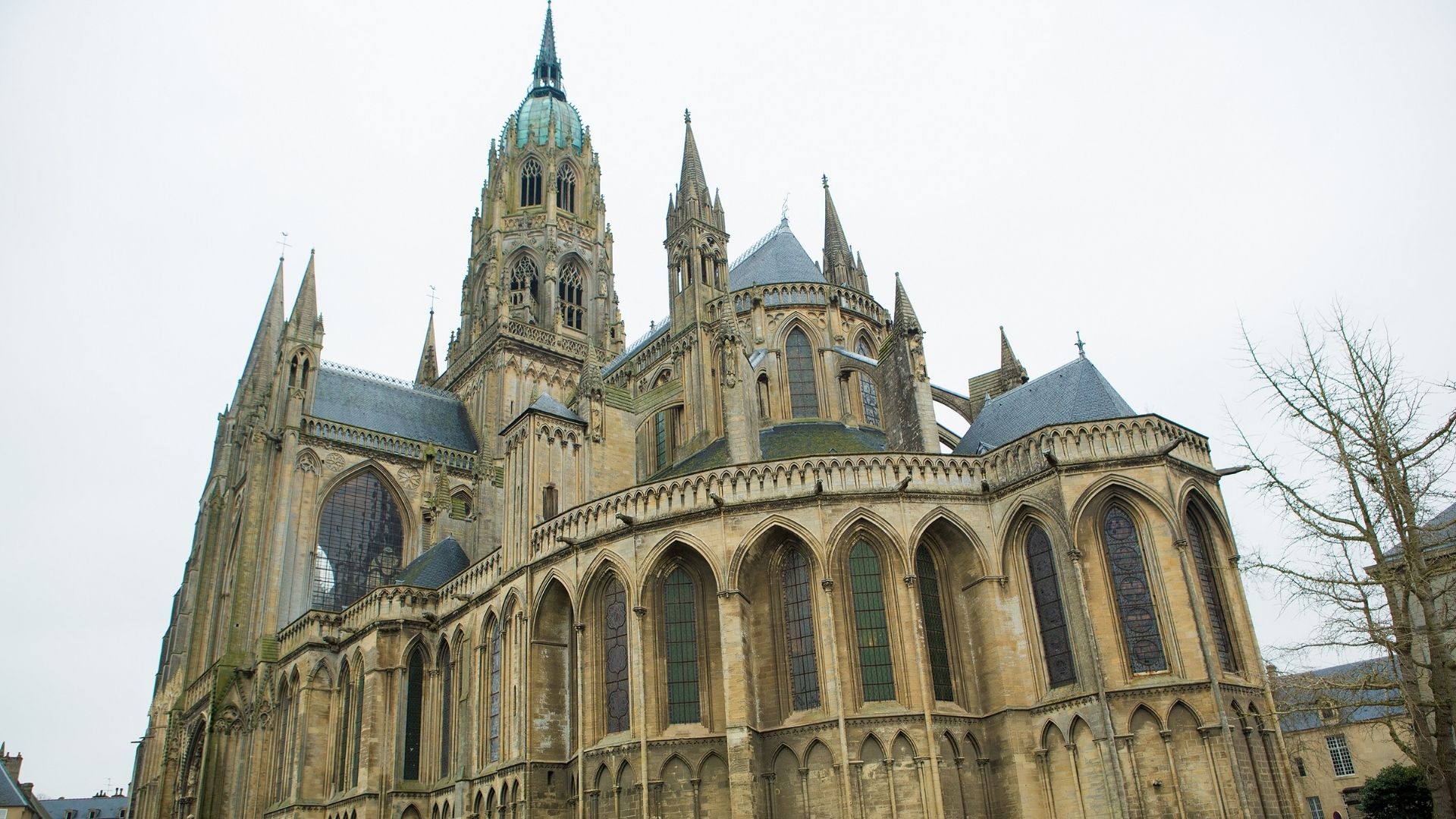 Bayeux Cathedral Exterior Norman Gothic Architecture Apse Paris Beyond Tours Bayeux Cathedral exterior Norman Gothic architecture apse flying buttresses copper dome - Paris and Beyond Tours Bayeux walking city tour