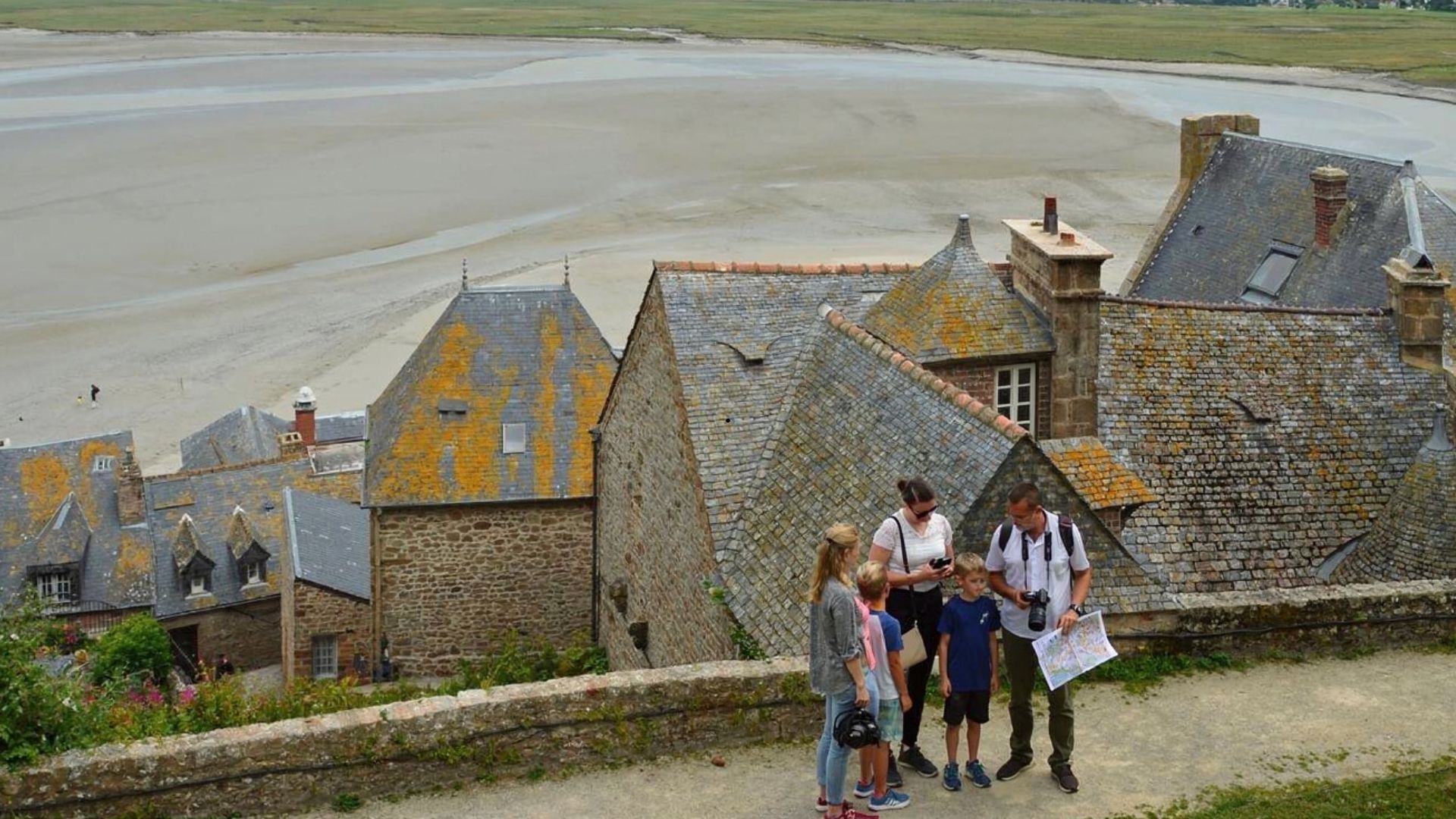 Mont Saint-Michel Family Tour Tidal Bay Medieval Village Paris Beyond Tours Family guided tour Mont Saint-Michel tidal bay medieval rooftops low tide - Paris and Beyond Tours private tour from Bayeux Caen