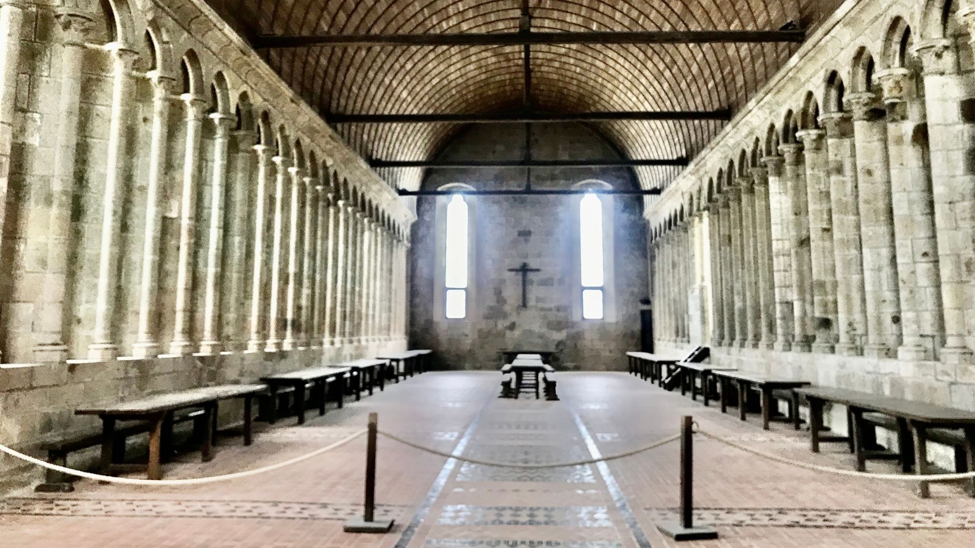 Mont Saint-Michel Abbey Refectory | Paris and Beyond Tours Interior Architecture Experience Mont Saint-Michel abbey Gothic refectory with barrel vault ceiling and rows of Romanesque columns - Paris and Beyond Tours private guided interior tour from Bayeux Caen
